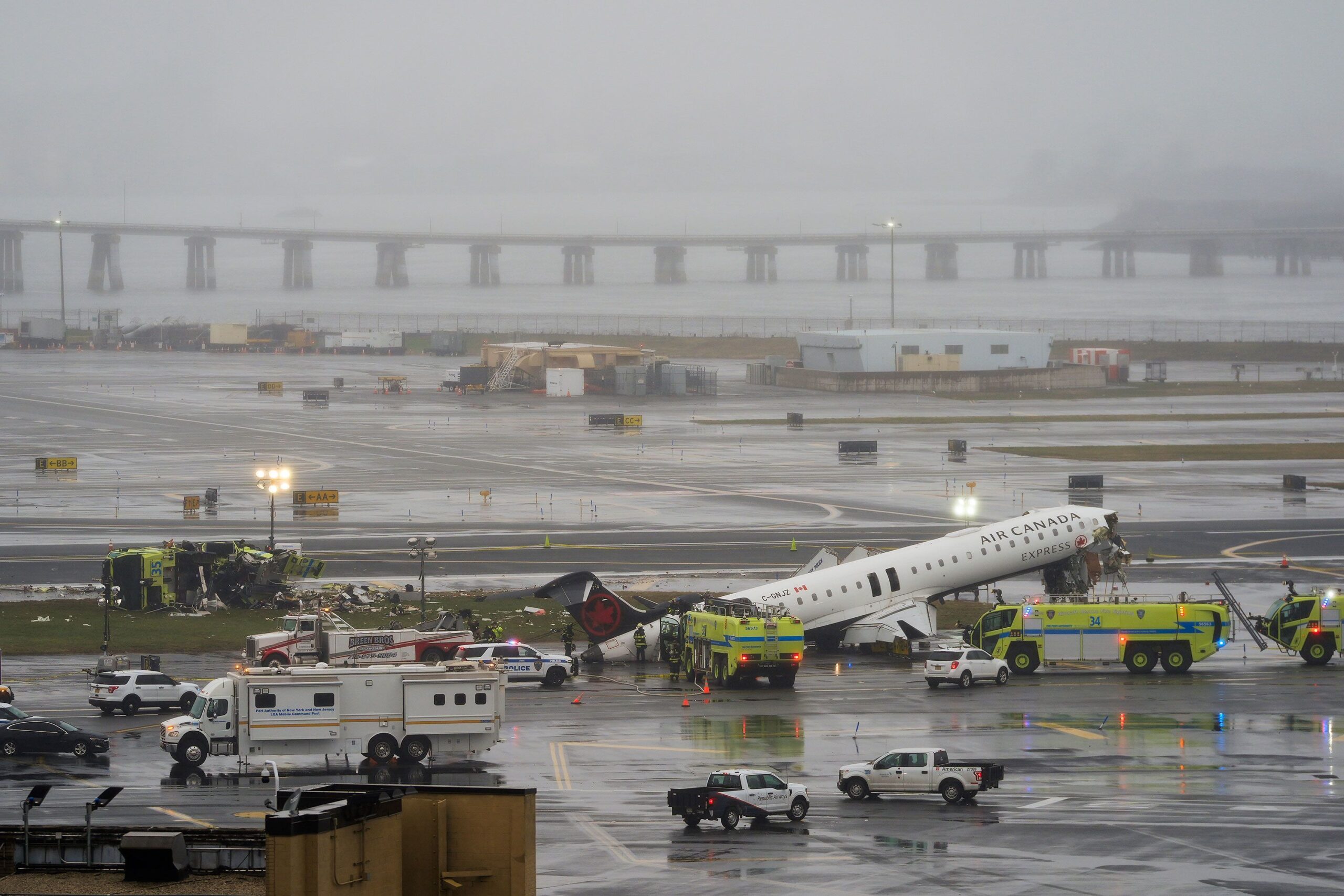 <i>Seth Wenig/AP via CNN Newsource</i><br/>An Air Canada jet and Port Authority fire truck sit on the runway at LaGuardia Airport