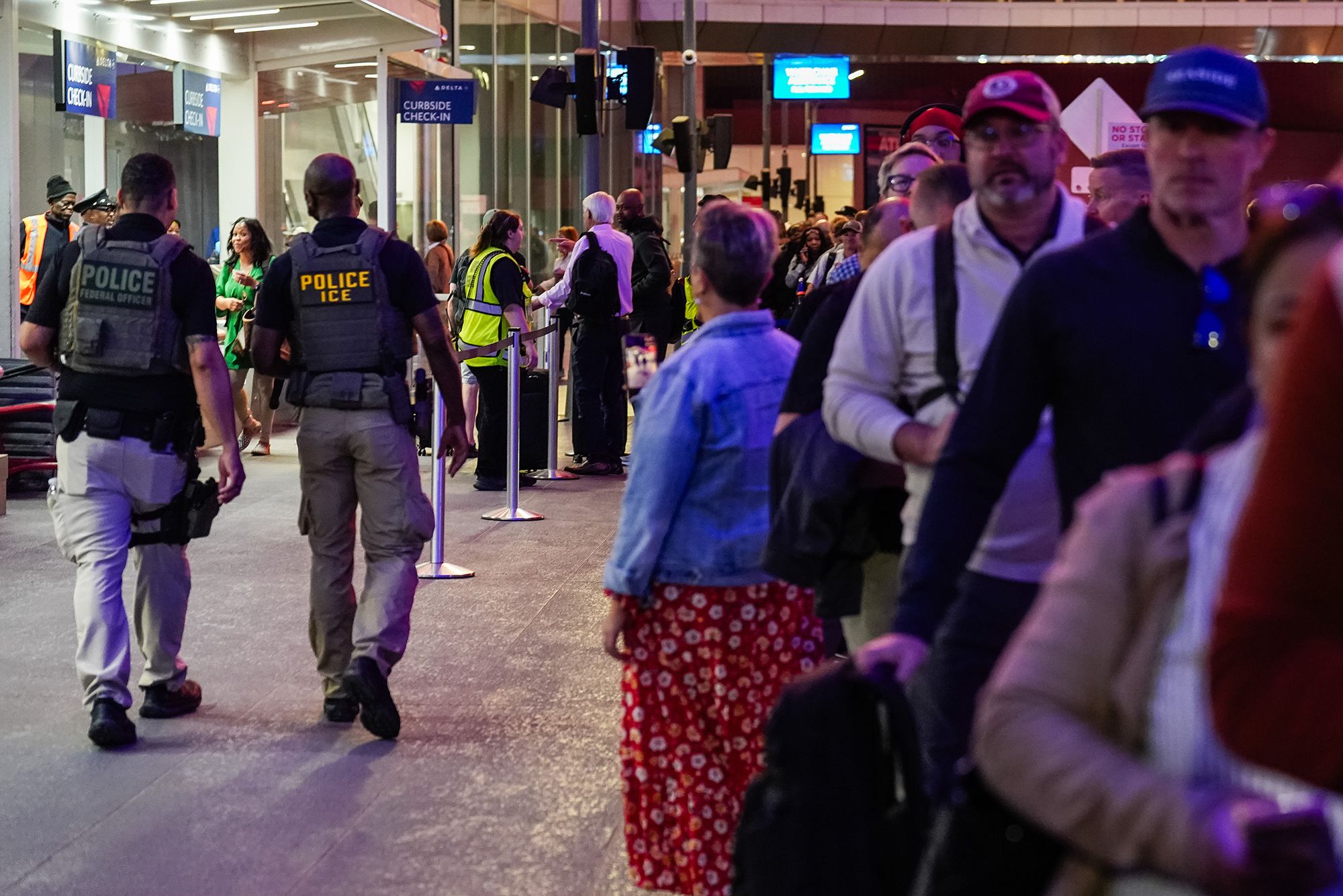 <i>Elijah Nouvelage/Bloomberg/Getty Images via CNN Newsource</i><br/>An Immigration and Customs Enforcement agent is seen at a TSA checkpoint at Atlanta’s international airport.