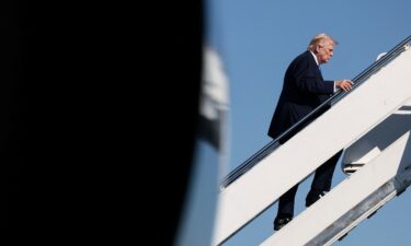 President Donald Trump boards Air Force One as he departs West Palm Beach