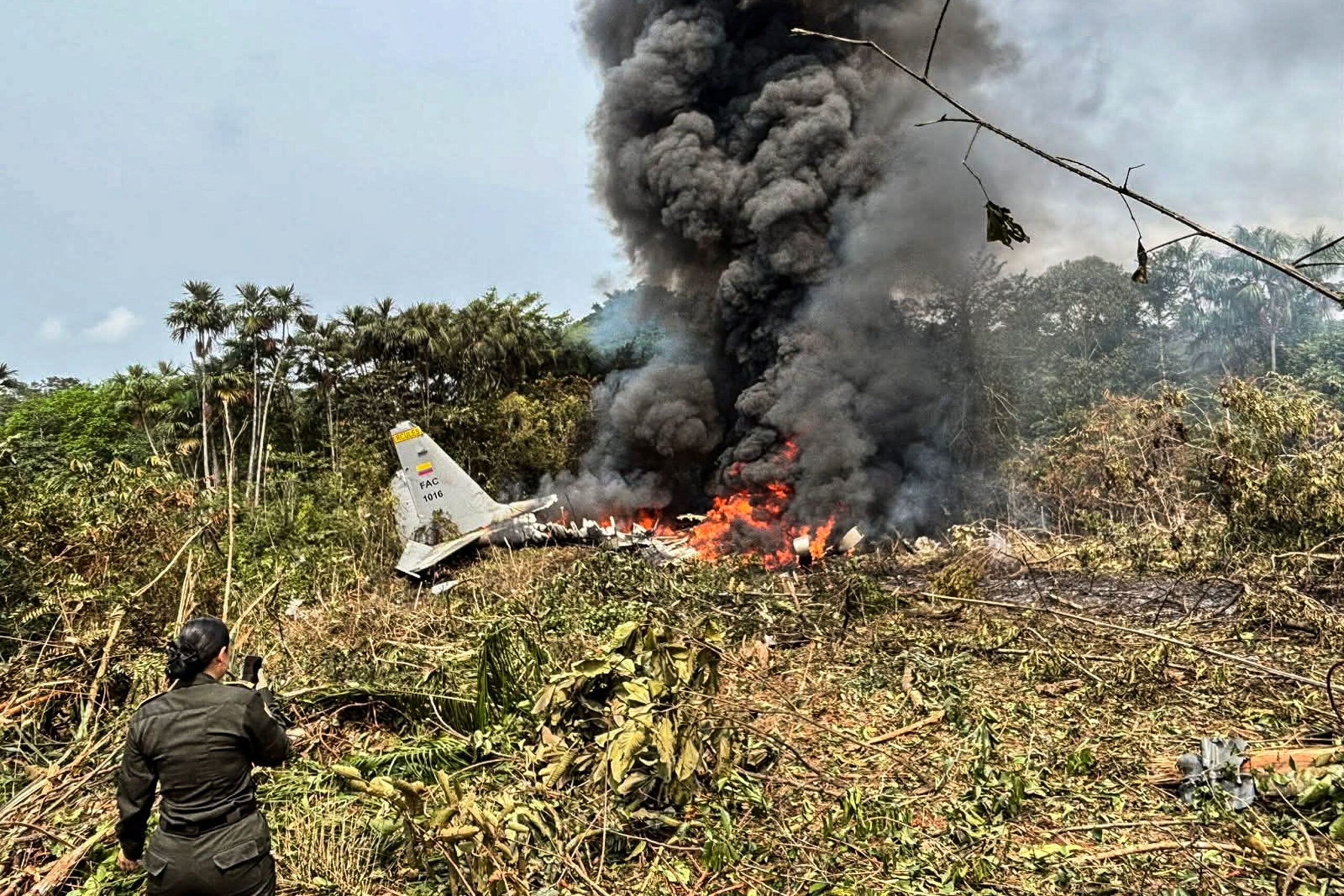 <i>Daniel Ortiz/AFP via Getty Images via CNN Newsource</i><br/>Flames and thick black smoke rise from the Colombian military plane that crashed in Puerto Leguizamo