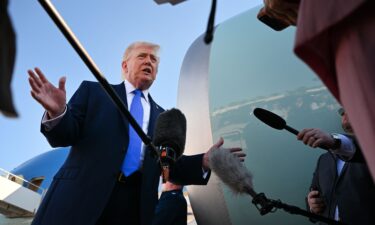 President Donald Trump speaks to reporters before boarding Air Force One at Palm Beach International Airport on Monday in West Palm Beach
