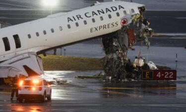 Debris hangs from an Air Canada jet Monday at New York's LaGuardia Airport.