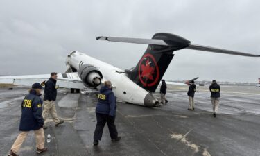 NTSB investigators at the scene of collision between an Air Canada Express plane and a firefighting vehicle at LaGuardia Airport on Monday