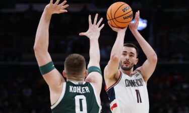 UConn forward Tarris Reed Jr. dunks as Michigan State forward Cameron Ward defends during the first half in their Sweet 16 game on Friday.