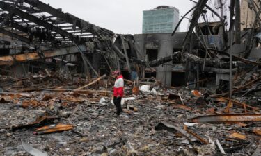 A member of the Iranian Red Crescent Society stands at Hypercar
