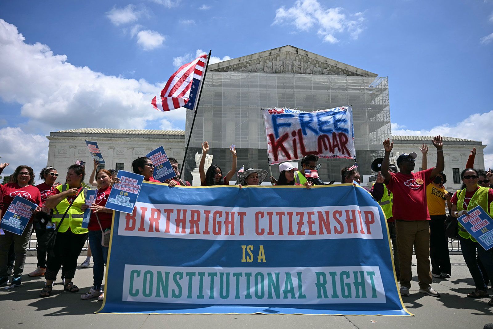 <i>Jim Watson/AFP/Getty Images/File via CNN Newsource</i><br/>People hold a banner as they participate in a protest outside the US Supreme Court over President Donald Trump's move to end birthright citizenship on May 15
