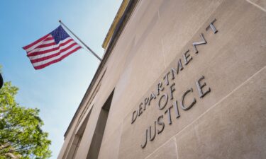 A sign marks the location of the U.S. Department of Justice (DOJ) headquarters building on April 30