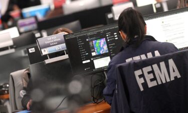 A FEMA employee works at the National Response Coordination Center at the headquarters for the Federal Emergency Management Agency in Washington