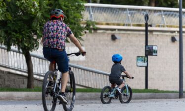 A man and a child ride bicycles in the Bicentenario Park in Santiago on January 28.