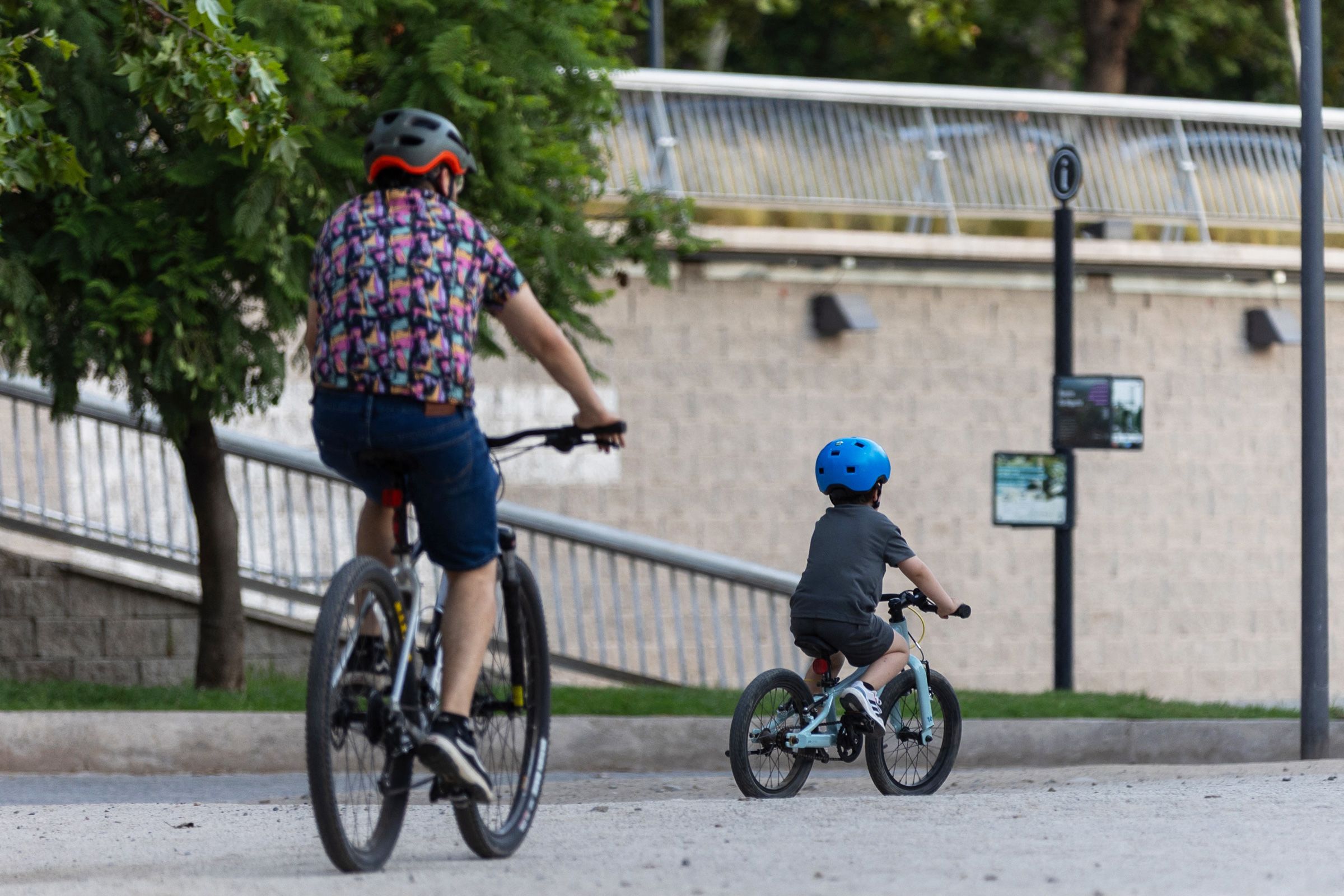 <i>Raul Bravo/AFP/Getty Images via CNN Newsource</i><br/>A man and a child ride bicycles in the Bicentenario Park in Santiago on January 28.