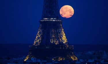The full pink moon graces the evening sky in Paris in April 2024.