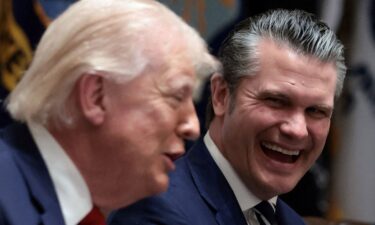 A person stands on the roof after a strike on Tehran