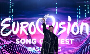 Austrian singer JJ celebrates with the 2025 Eurovision Song Contest trophy after winning the grand final at the St. Jakobshalle arena in Basel on May 18
