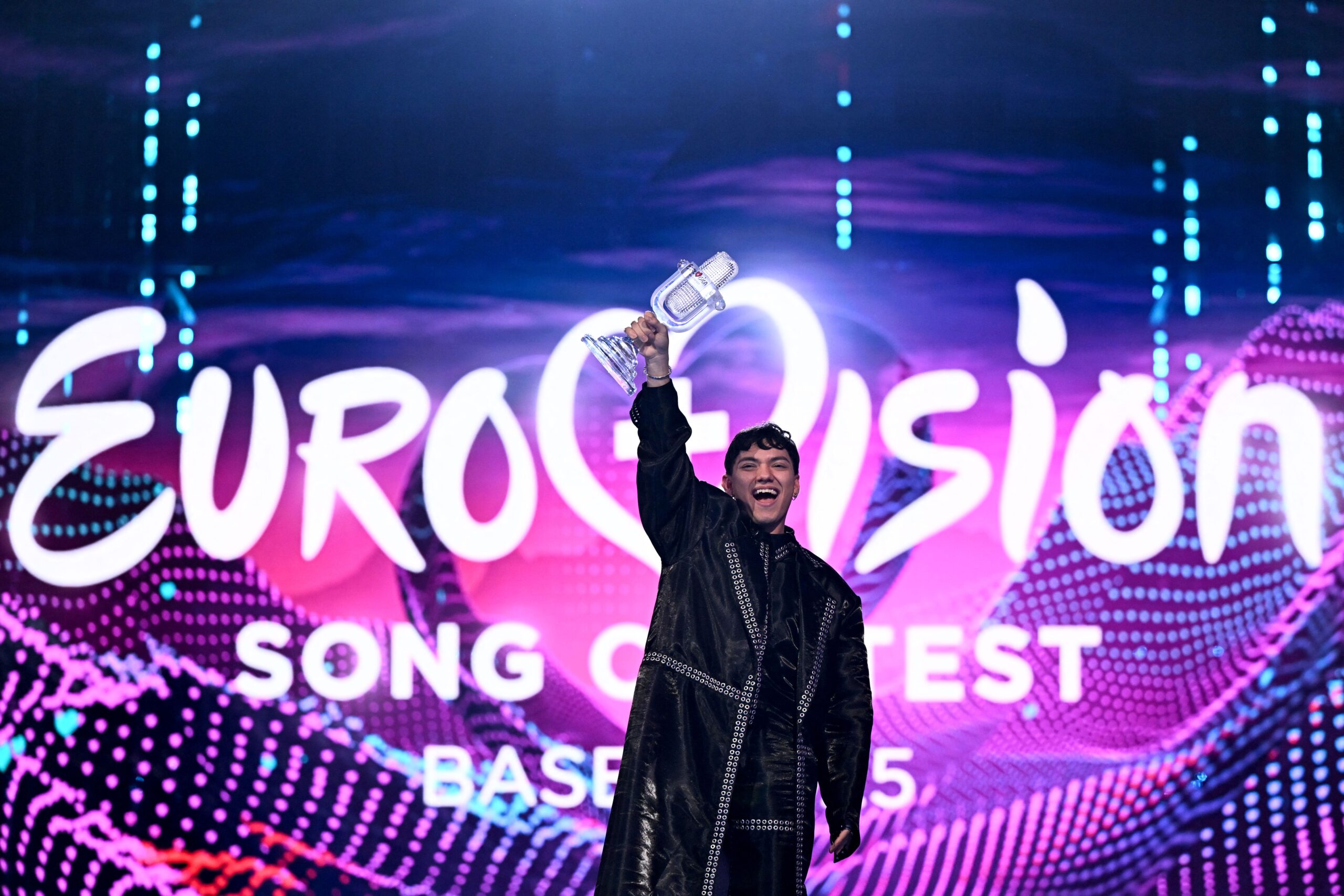 <i>Fabrice Coffrini/AFP/Getty Images via CNN Newsource</i><br/>Austrian singer JJ celebrates with the 2025 Eurovision Song Contest trophy after winning the grand final at the St. Jakobshalle arena in Basel on May 18