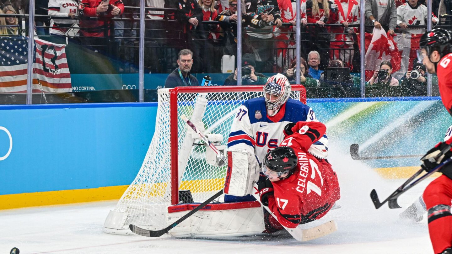 <i>NBC Olympics</i><br/>Connor Hellebuyck saves a shot attempt by Canada's Macklin Celebrini.