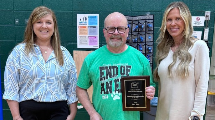 Becky Arway and Nicole Clay, chairs of the Professional Recognition Committee for the Northwest Missouri School Counselor Association, presented the award to Dave Wing.