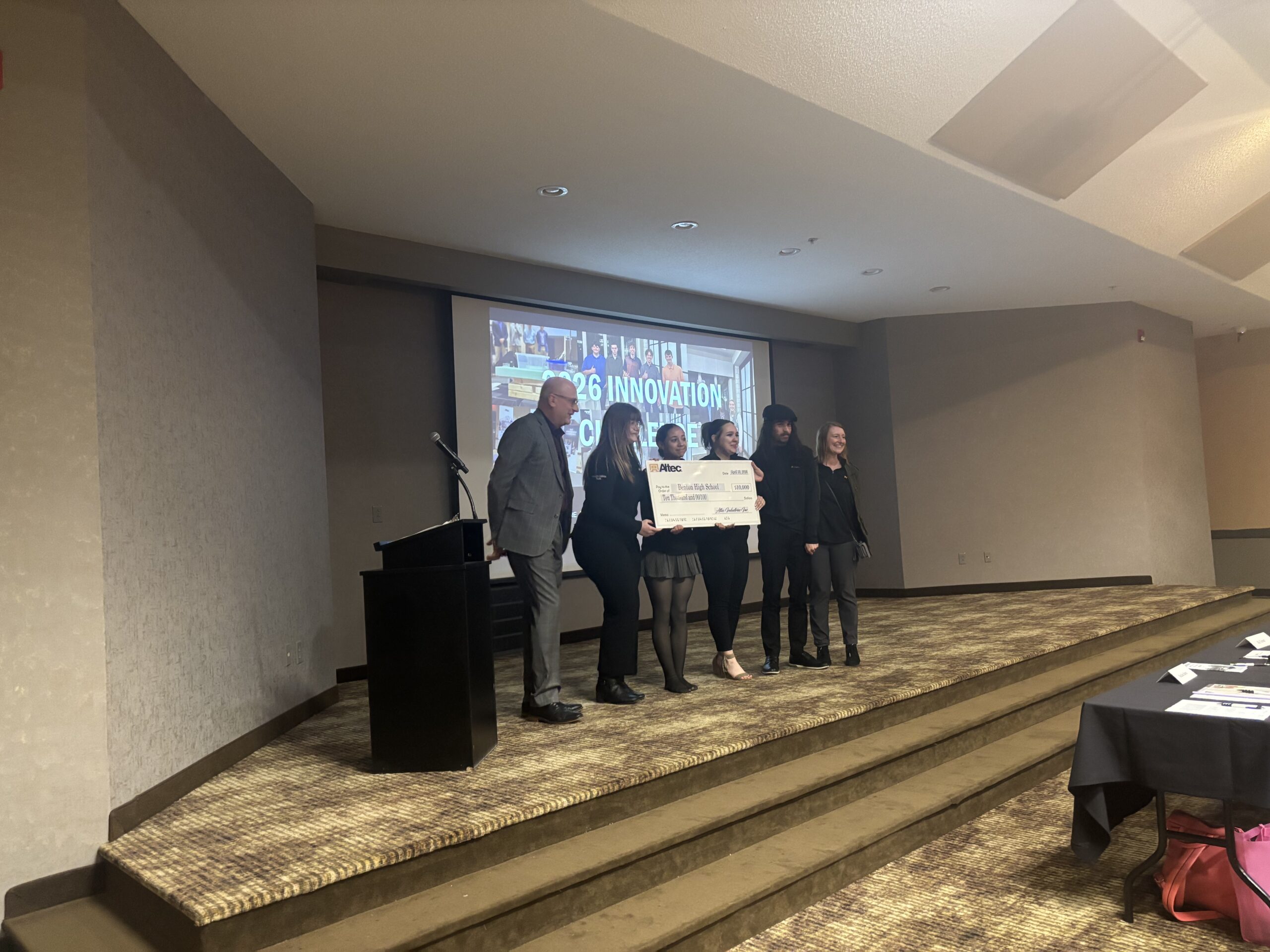 Benton High School students holding $10,000 check.