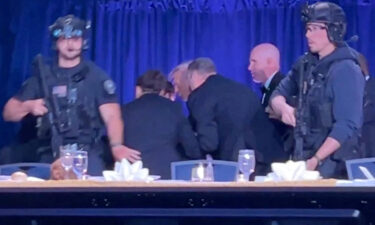 U.S. President Donald Trump is escorted out as a shooter opens fire during the annual White House Correspondents' Association dinner on April 25.