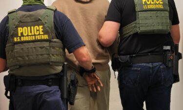 Federal agents detain a man after his court hearing in immigration court in July 2025