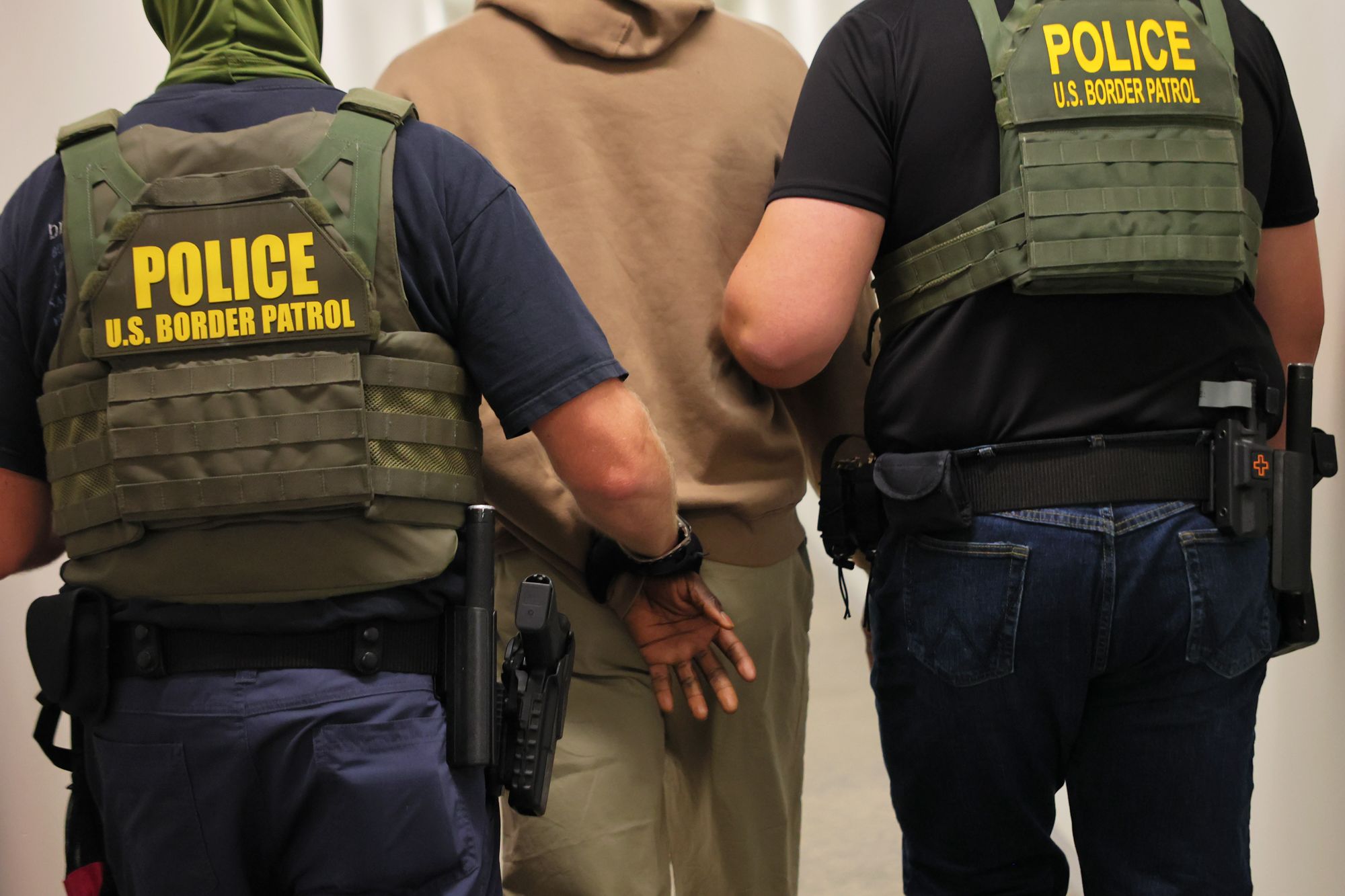 <i>Michael M. Santiago/Getty Images/File via CNN Newsource</i><br/>Federal agents detain a man after his court hearing in immigration court in July 2025