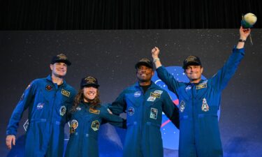 (From left) Members of the International Space Station and Artemis II crews are seen on the screens inside the ISS flight control room in the Mission Control Center at NASA's Johnson Space Center in Houston. The two crews connected in a 15-minute ship-to-ship call on April 7.