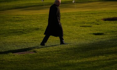 President Donald Trump walks on the South Lawn of the White House on March 23.