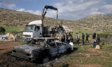 Residents remove a torched tractor on Tuesday that