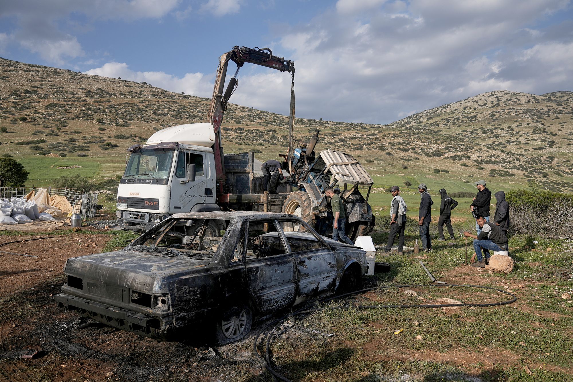 <i>Majdi Mohammed/AP via CNN Newsource</i><br/>Residents remove a torched tractor on Tuesday that