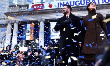 New York Mayor Zohran Mamdani stands on stage with his wife
