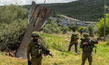 Workers inspect damage caused by a drone strike overnight at a hotel in Dubai