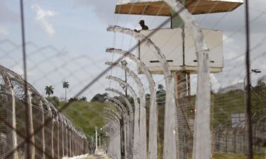 A military guard observes from a watch tower at the Combinado del Este prison during a media tour in Havana