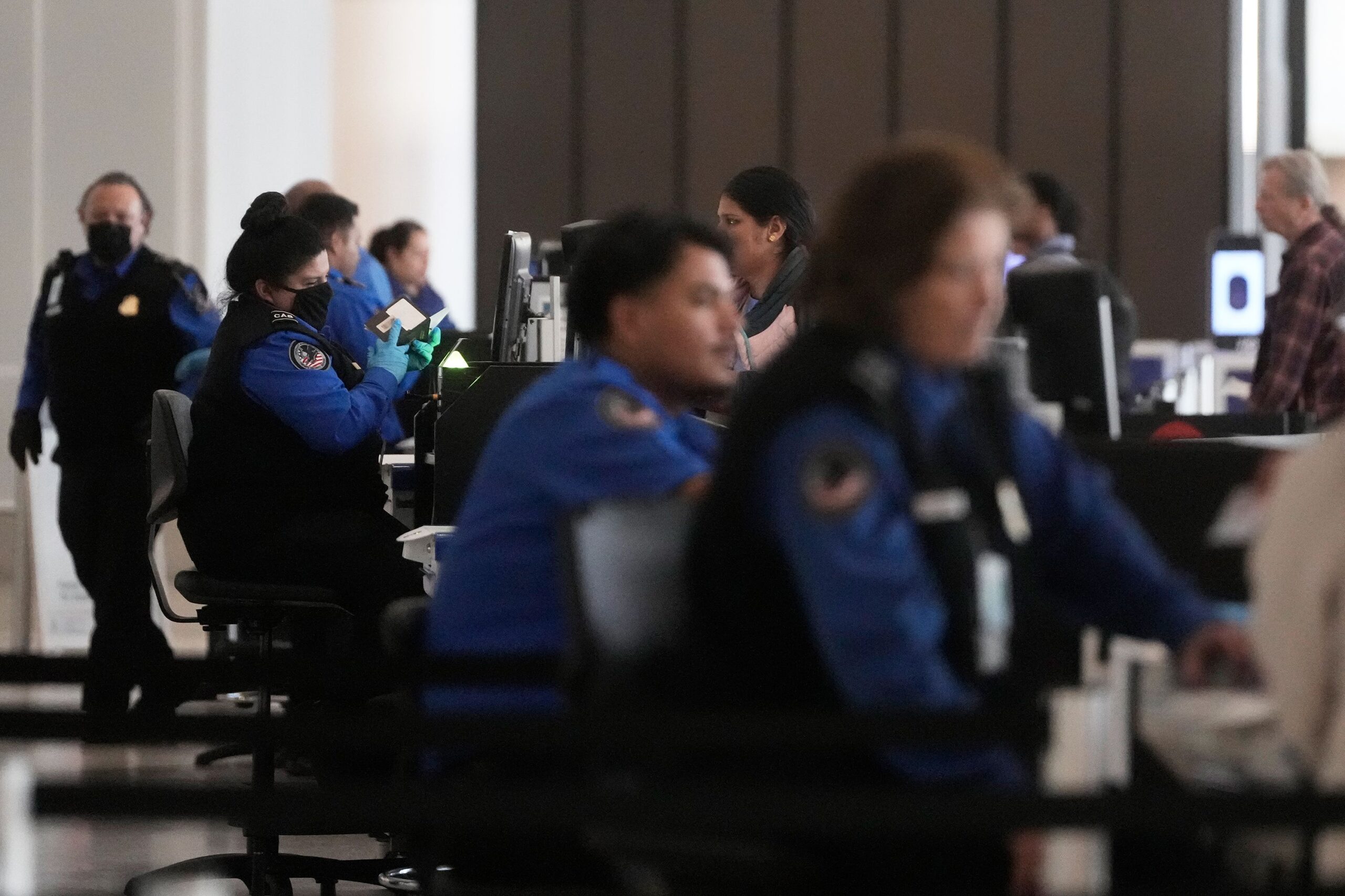 <i>Jeff Chiu/AP via CNN Newsource</i><br/>Covenant Aviation Security Private Security Services agents check in passengers at a security gate at San Francisco International Airport.