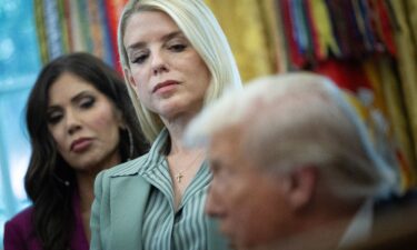 Kristi Noem and Pam Bondi listen as President Donald Trump speaks during an event in the Oval Office on September 15.