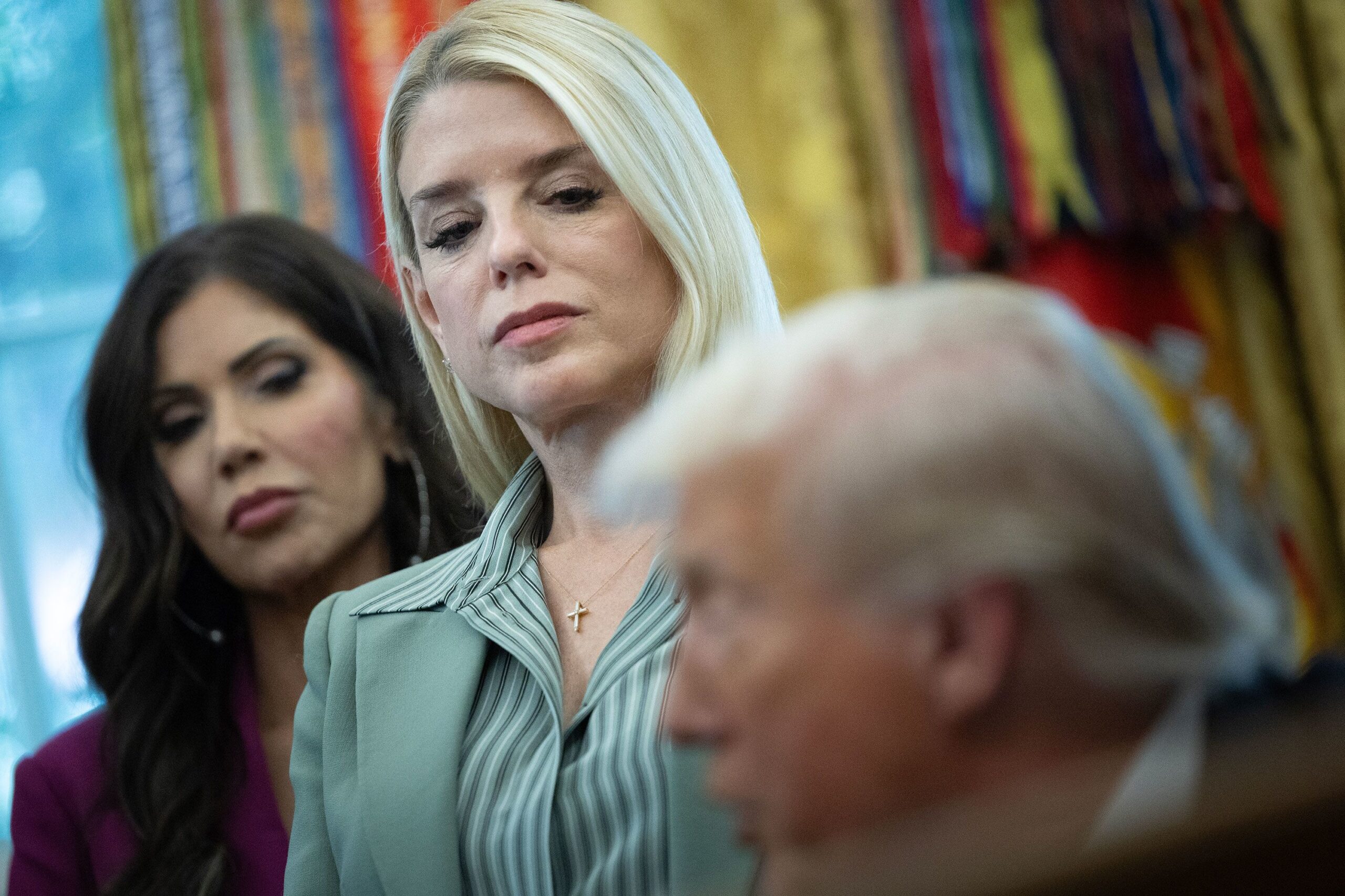 <i>Tom Brenner For The Washington Post via Getty Images via CNN Newsource</i><br/>Kristi Noem and Pam Bondi listen as President Donald Trump speaks during an event in the Oval Office on September 15.