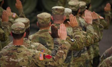 US Army soldiers raise their right hands as President Donald Trump conducts during a re-enlistment ceremony in Washington