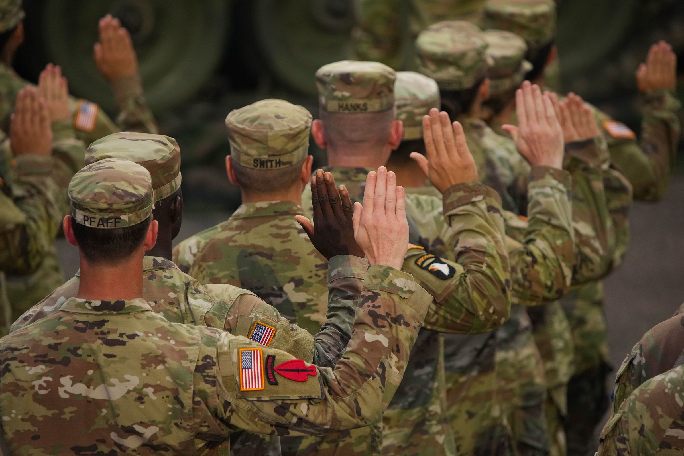 <i>Andrew Harnik/Getty Images/File via CNN Newsource</i><br/>US Army soldiers raise their right hands as President Donald Trump conducts during a re-enlistment ceremony in Washington