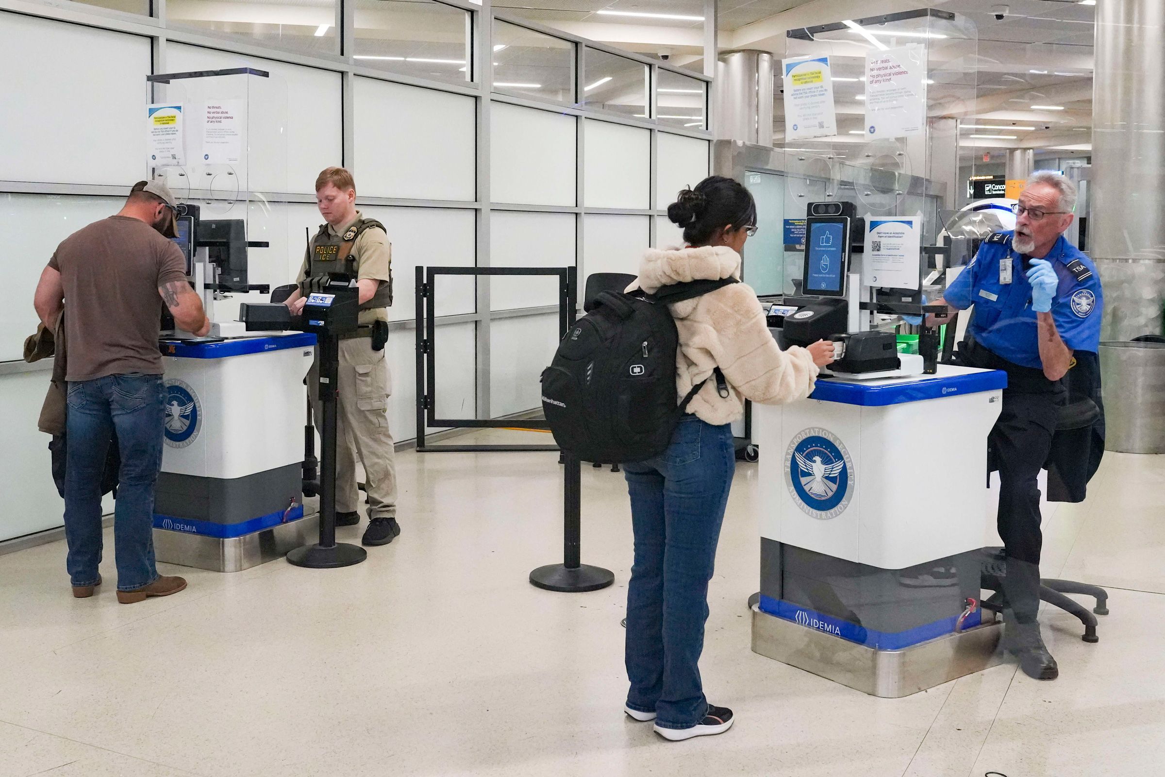 <i>Megan Varner/Getty Images via CNN Newsource</i><br/>An ICE agent and TSA member check IDs at a security counter at Hartsfield-Jackson Atlanta International Airport on March 28.