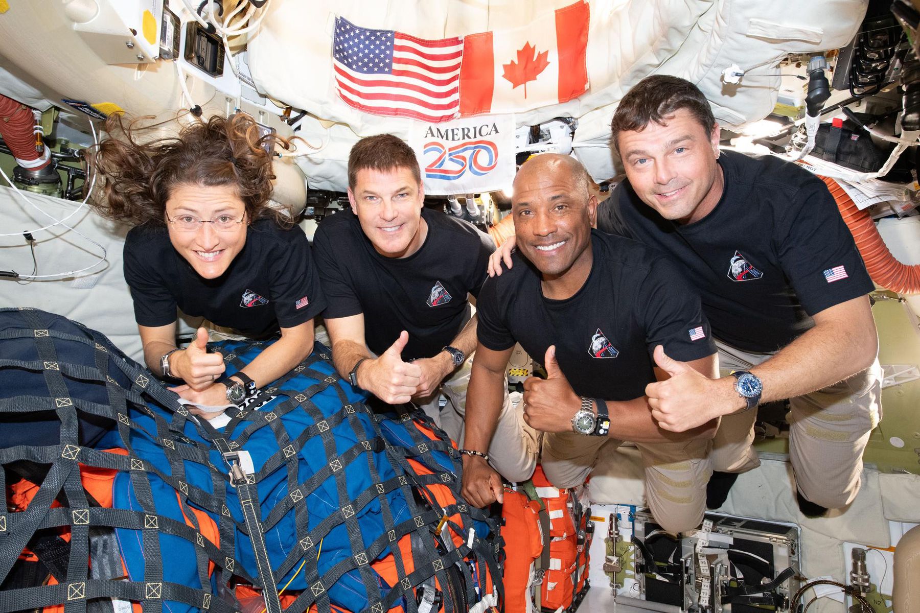 <i>NASA via CNN Newsource</i><br/>Artemis II crew members Christina Koch (left) and Victor Glover (middle right) can be seen wearing wrist devices that measure their sleep and wellbeing.