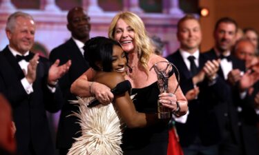 Nadia Comăneci is presented with the Laureus Lifetime Achievement Award by Simone Biles.