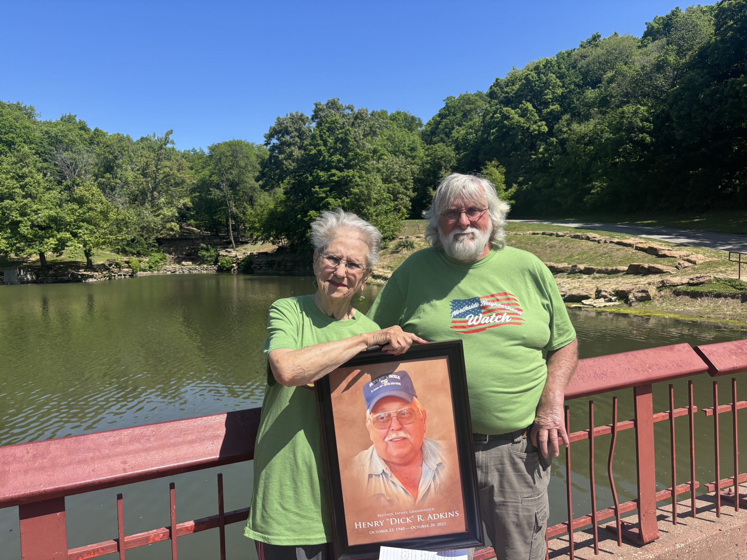 The Northside Neighborhood Watch Association chairman  Pat Jones (Left) and vice president John Holland (Right) holding memorial photo of Henry “Dick” R. Adkins.