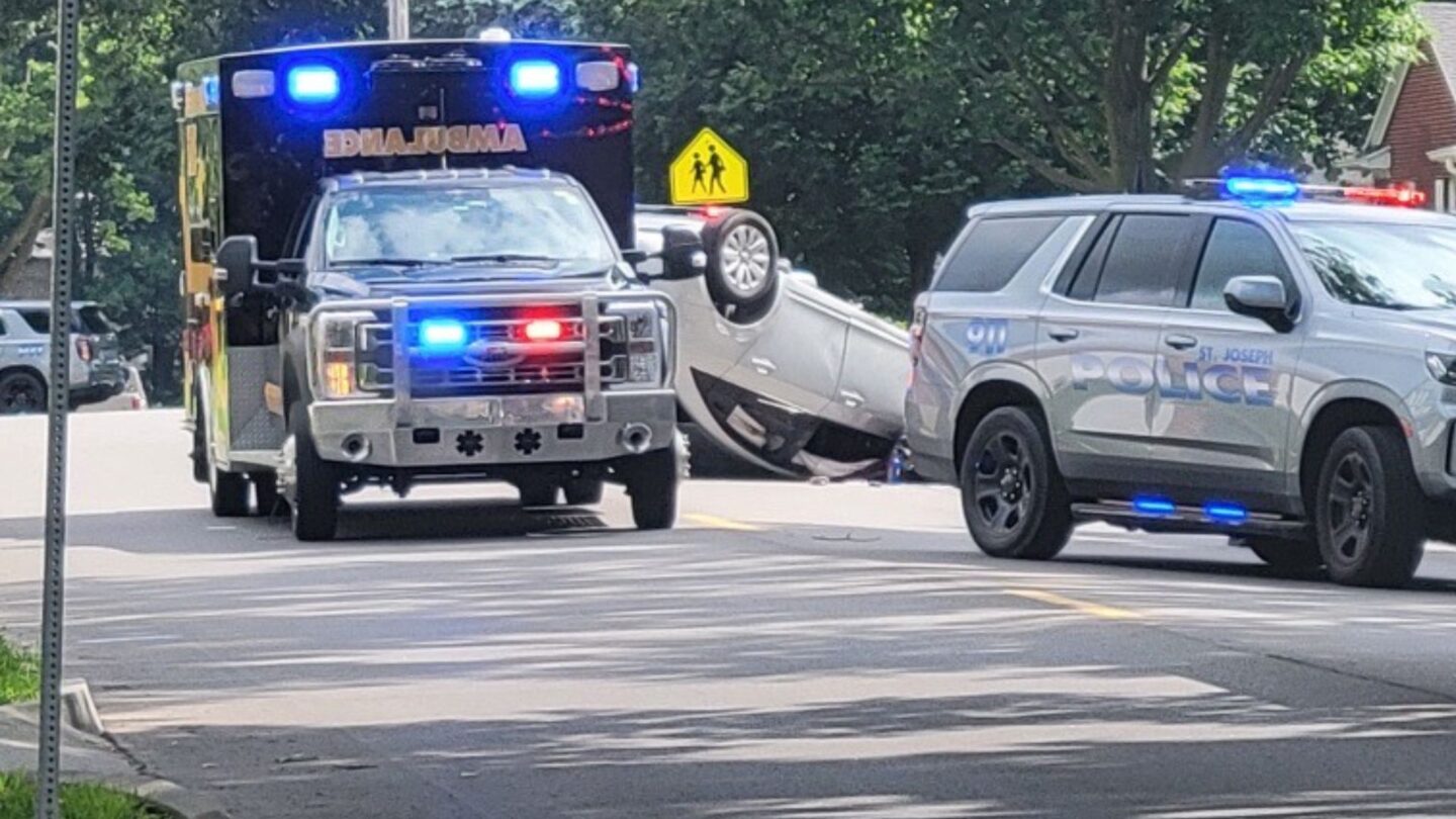 A white vehicle is flipped on its roof with airbags deployed along Lovers Lane Monday morning. 