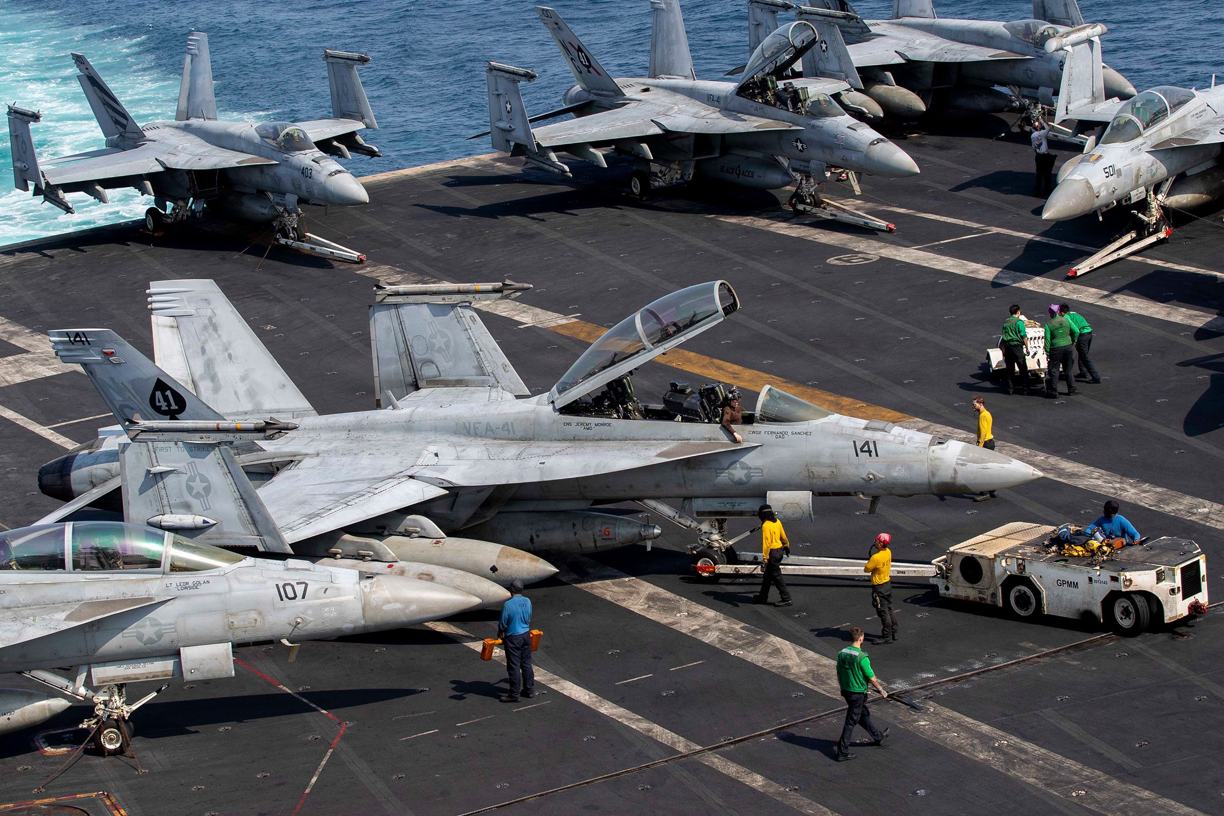 U.S. Sailors taxi an F/A-18F Super Hornet on the flight deck aboard Nimitz-class aircraft carrier USS Abraham Lincoln in support of Operation Epic Fury, on March 17.