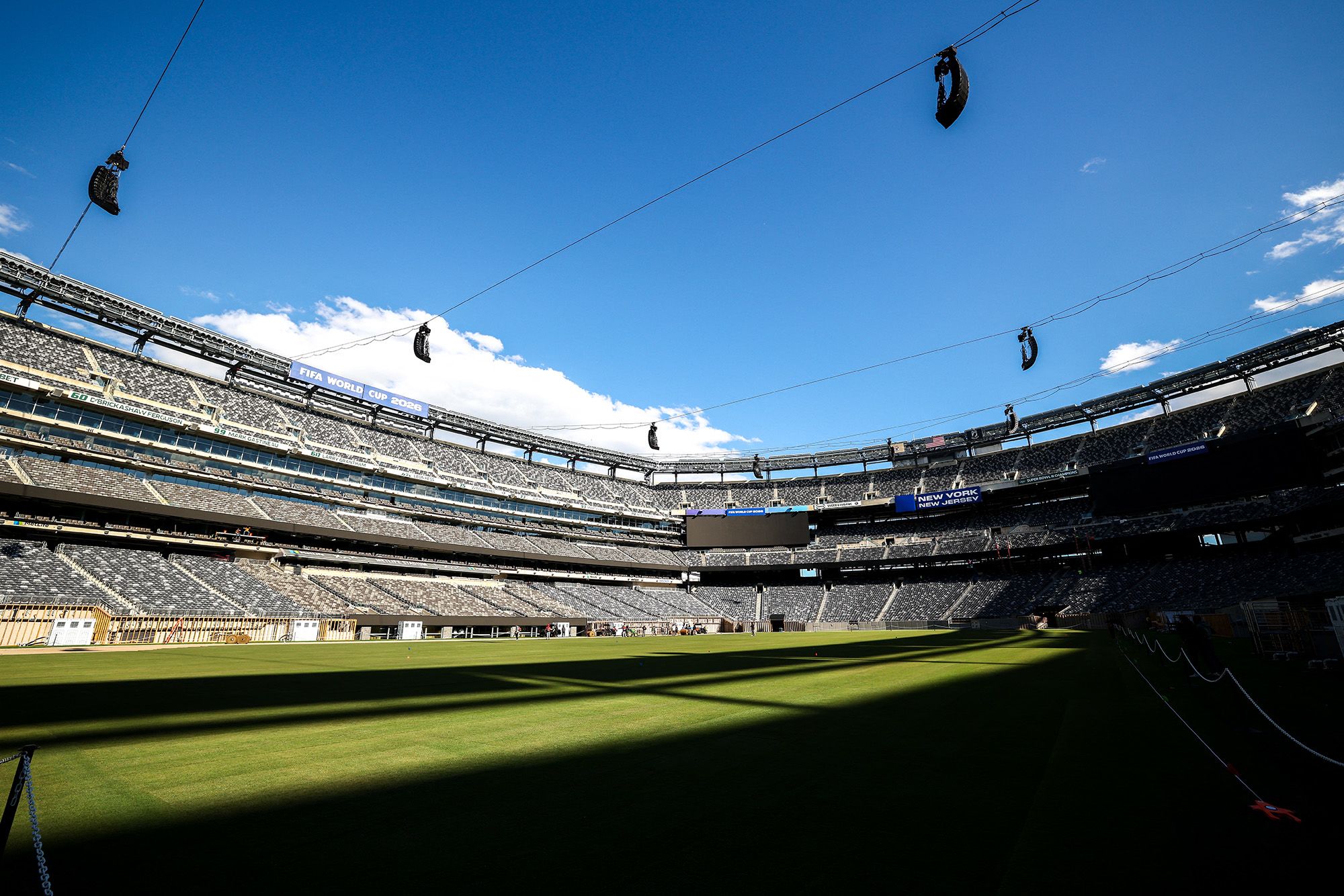 Workers install the pitch at New York New Jersey Stadium, which is temporarily renamed from MetLife stadium, ahead of the 2026 FIFA World Cup.