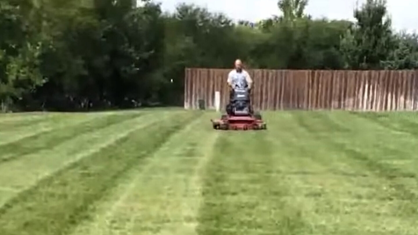 An individual mowing their lawn 