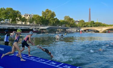 Triathlon athletes dive in the Seine river with The Eiffel Tower in the background during a Test Event for the women's triathlon for the upcoming 2024 Olympic Games in Paris