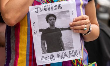 A person holds a flyer that reads "Justice for Nolan" outside the National Action Network headquarters in New York City on July 10.
