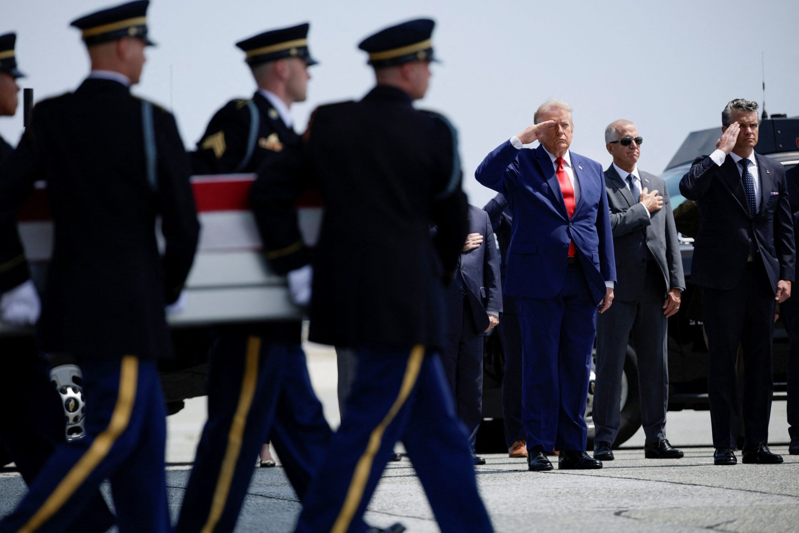 <i>Evan Vucci/Reuters via CNN Newsource</i><br/>President Donald Trump salutes as transfer cases for fallen soldiers are carried at Dover Air Force Base in Delaware on July 22.