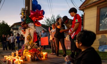 Family members of Lorenzo Salgado Araujo grieve at a makeshift memorial during a candlelight vigil on July 8 in Houston