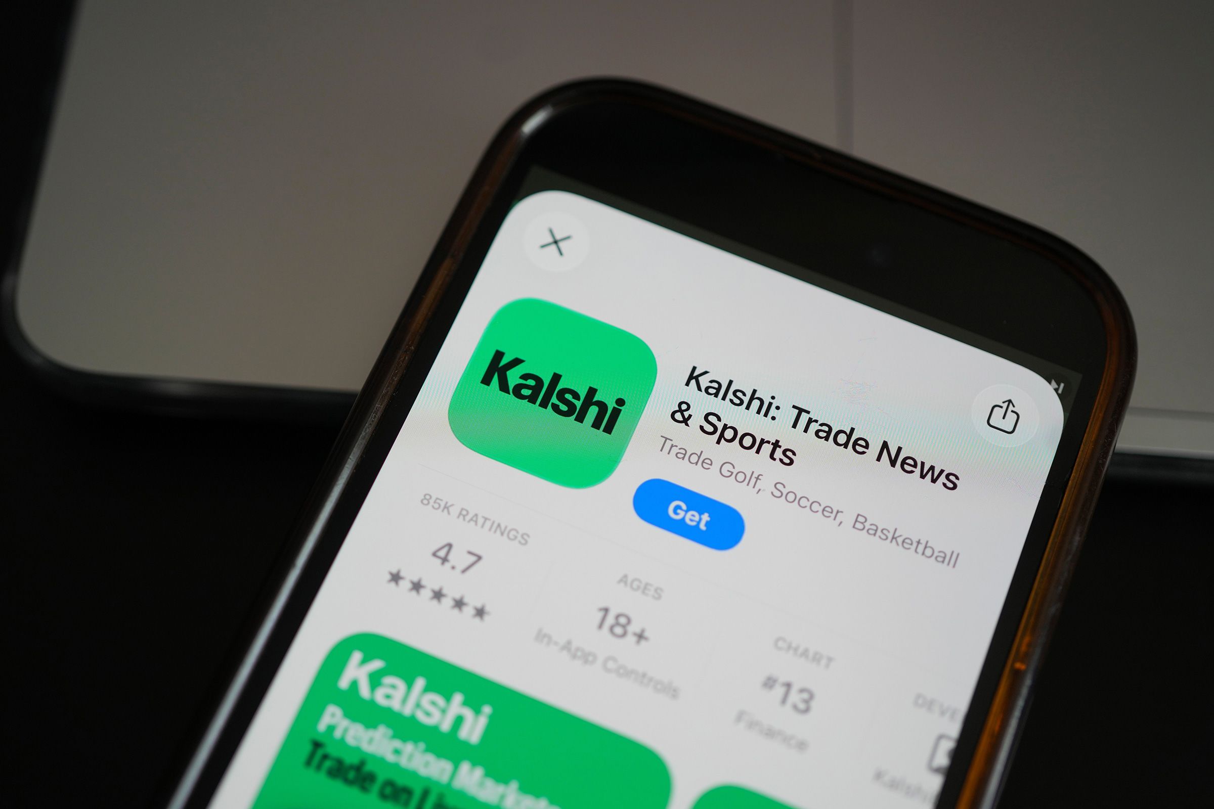 <i>Erin Hooley/AP via CNN Newsource</i><br/>An ad for the prediction market app Kalshi is displayed on a mobile phone in Chicago