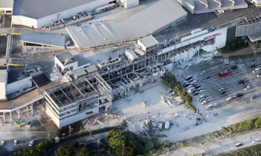The exterior wall of a shop is seen collapsed in Tuesday's earthquake in Kumamoto City.